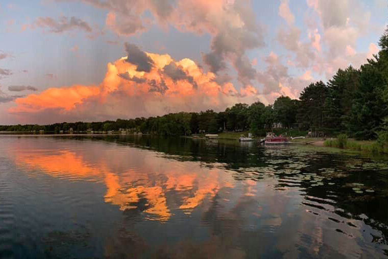 Orange clouds reflected on lake